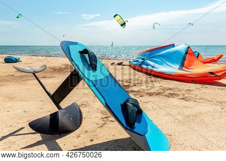 Close-up Hydrofoil Surf Board And Kite Equipment On Sand Beach Shore Watersport Spot On Bright Sunny