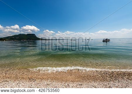 Beautiful Beach On Lake Garda (lago Di Garda) In Front Of The Small Town Of Garda. Headland Of San V