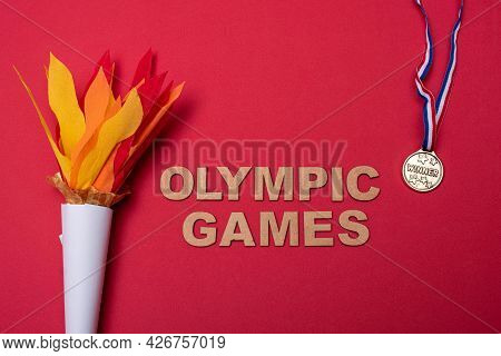 Xalapa, Veracruz, Mexico- July 8, 2021: Paper Torch And Medal On Red Background. 