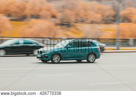 Fast Moving Bmw X3 G01 On The City Road. Blue Suv With Man Driving. Premium Auto In Fast Motion With