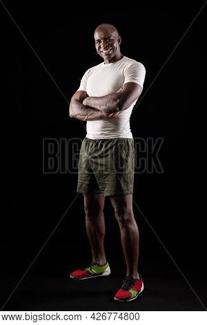 Portrait Of African American Sportsman Posing With Crossed Arms At Studio