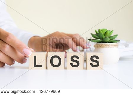 The Word Loss, Spelt On Wooden Cubes With Letters Over A White Background