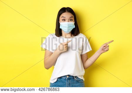 Covid-19, Pandemic And Social Distancing Concept. Surprised And Happy Asian Woman In Medical Mask, S