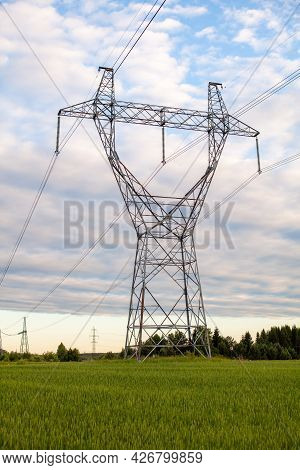 Metal Poles Electric Supports For High-voltage Wires In The Fields In The Summer.high Voltage Poles 