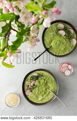 Top View Of A Table With Two Plates Of Creamy Spinach Broccoli Soup, Soup Decorated With Microgreens