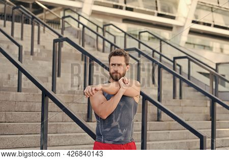 Preparing His Muscles. Fitness Man Warming Up In The Gym. Having A Good Stretch. Handsome Man In Spo