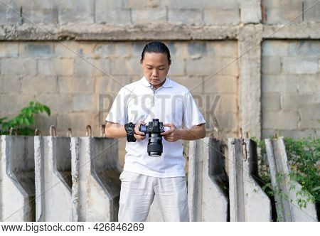 Asian Thai - Chinese Professional Camera Man Posts And Check Image Shot Via Liveview Behind Medium F