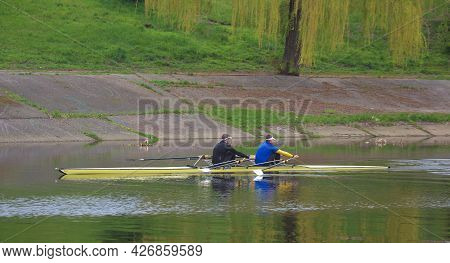 Kyiv Ukraine, The Dnieper River - May 02 2021: Two Unknown Young Athletes Are Sailing In A Two-seate