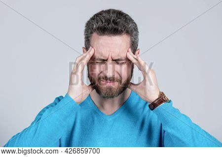 Mature Man With Beard Suffer From Headahce On Grey Background, Health