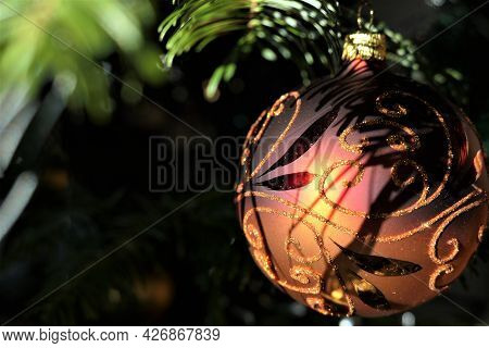 Hanging Red Christmas Decoration With Gold Applications On The Tree
