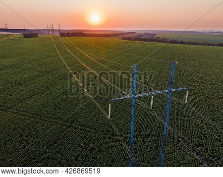 High Voltage Power Line On Industrial Electricity Line Tower For Electrification Rural Countryside. 