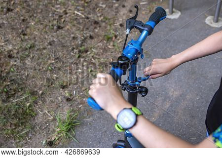 The Wheel Of A Scooter. Adjusting The Position Of The Scooter Steering Wheel. The Guy Adjusts The He