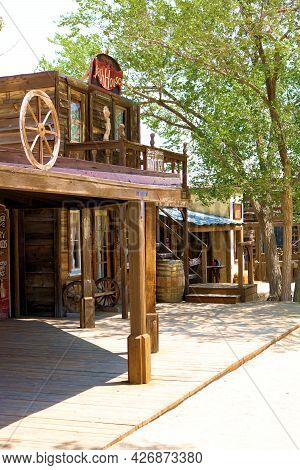July 14, 2021 In Pioneertown, Ca:  Rustic Boardwalk Besides Vintage Wooden Buildings And Cottonwood 