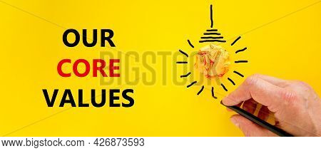 Our Core Values Symbol. Businessman Writing Words 'our Core Values', Isolated On Beautiful Yellow Ba