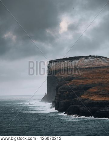 Waves crashing against the cliff in the north of Faroe island 