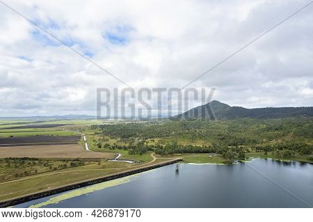 High Aerial Of Kinchant Dam Rock Wall, Water Catchment Area, And Farmland And Mountains Beyond. Quee