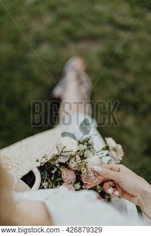 Woman with a woven bag full of flowers
