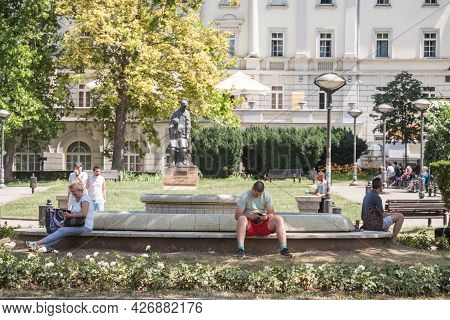 Belgrade, Serbia - June 26, 2021: Young Man And Old Senior Woman Sitting In Park Cirila I Metodija, 