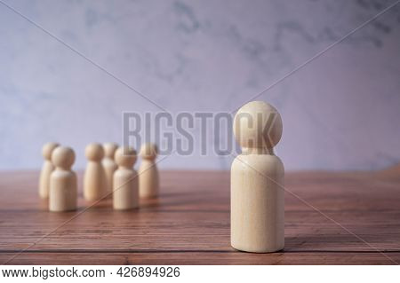 Wooden Figures Standing Out From Crowd.depicts The Ability Of Individual To Influence And Lead Follo