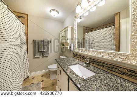 Traditional Bathroom Interior With Limestone Tiles And Vanity Unit With Granite Counter