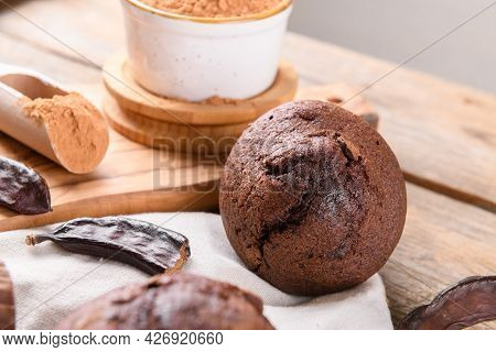 Chocolate Carob Cupcake Cooking With Carob Powder And Dried Carob Pods And Carob Powder In A Bowl Ov