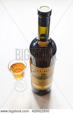 Moscow, Russia - June 10, 2021: Wine Glass And Bottle With Aged Fortified Wine Massandra Sherry From