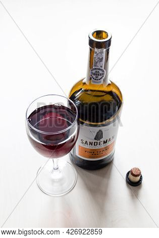 Moscow, Russia - June 10, 2021: Wineglass And Open Bottle Of Sandeman Fine Tawny Porto Wine. Sandema