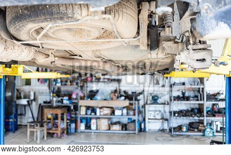 Bottom View Of Old Car With Broken Rear Shock Absorber (focus On Leaked Shock Absorber)