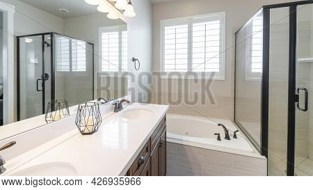 Pano Interior Of A Master Bathroom With Double Vanity Sink And Windows