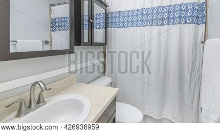 Pano Interior Of A Bathroom With Two Wall Mirror Cabinets With Wooden Frame