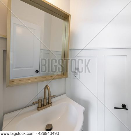 Square Frame Interior Of A Powder Room With A View Of Sink And Mirror