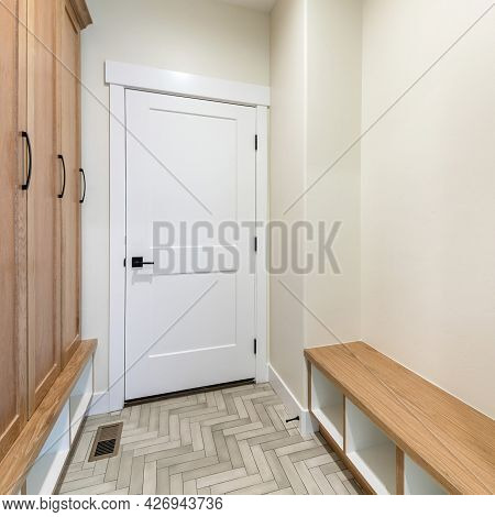 Square Frame Mudroom Interior With Herringbone Tile Pattern Flooring And Wooden Cabinet