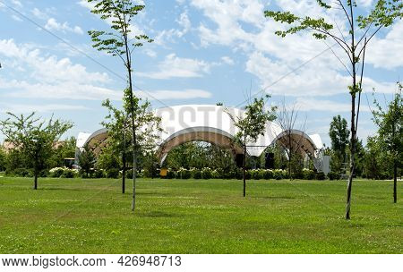 A White Tent For Celebrations In A Lovely Green Glade, Decorated With Garlands