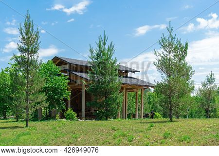 Beautiful Wooden Gazebo In A Green Clearing With Trees. A Place To Relax In Nature