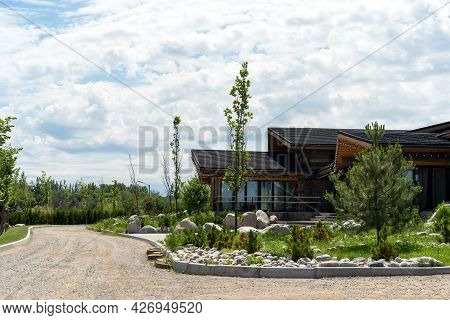 Beautiful Wooden House With Garlands On The Background Of Landscape Design