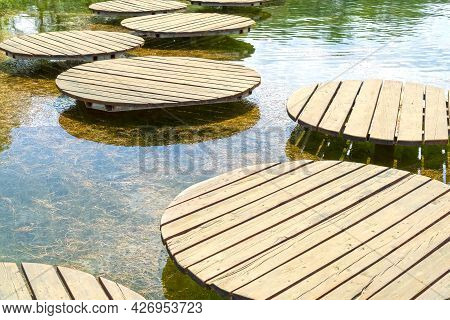 Wooden Round Bridges For People. Crossing The Pond To The Other Side