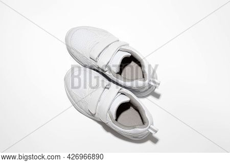 Flat Lay White Sneakers With Velcro Fasteners For Pregnant Women Or People With Disabilities Isolate