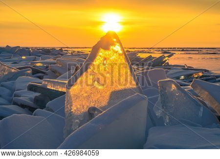 Beautiful Landscape Of Uzury Bay With Ice Hummock Rising Above The Frozen Lake Of Baikal At Sunrise.