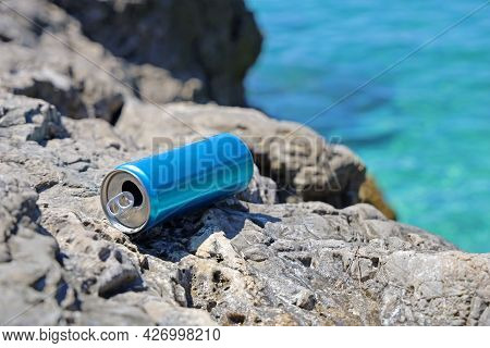 Blue Aluminum Beverage Can Left Behind On Stone Coast On Mediterriean, Problem Of Marine Pollution O