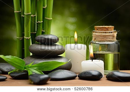 zen basalt stones and spa oil on the wood