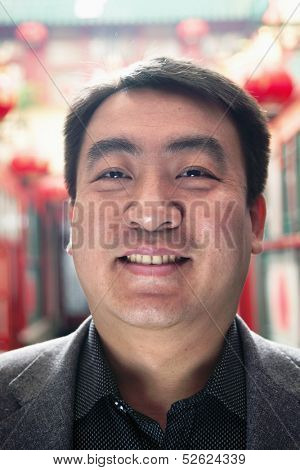 Portrait of mid adult man with Chinese lanterns in background