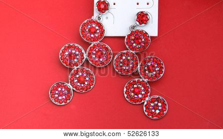 picture of fashion earrings on red background