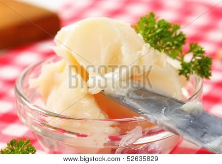 portion of pork lard with knife in a glass bowl