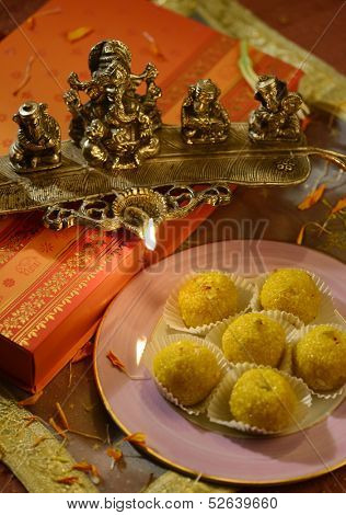 An box of Indian sweet and a traditional lamp