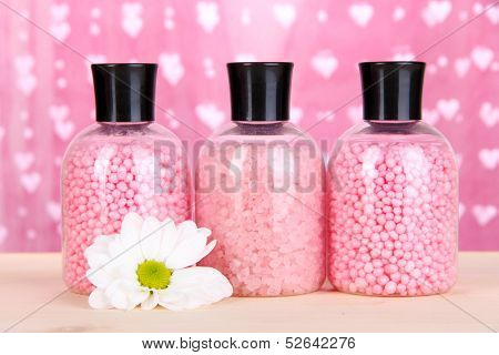Aromatherapy minerals - colorful bath salt on pink background