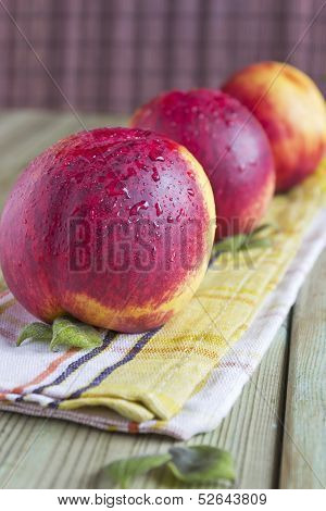 Three Ripe Peaches On The Table