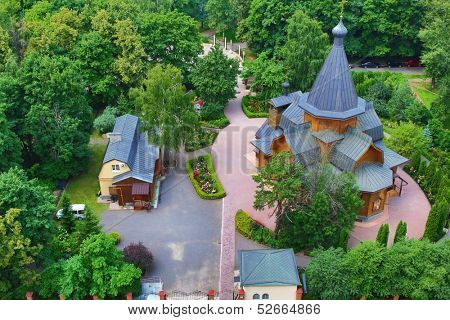 View at wooden Church of St. Nicholas in the Straw Gatehouse and church yard from high angle