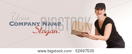Portrait of a laughing delivery girl in black carrying a parcel 