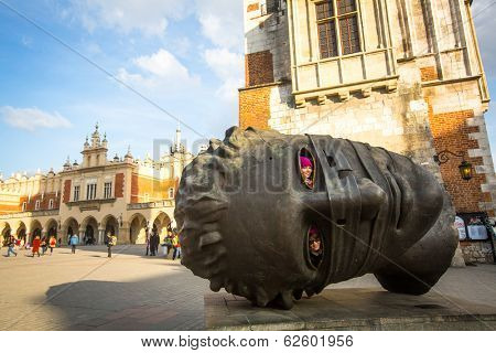 KRAKOW, POLAND - FEB 28, 2014: Igor Mitoraj's sculpture Eros Bendato (Eros Tied) 1999 on main square of the city. This worth about half a million euros bronze sculpture was donated to Krakow for free.