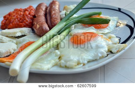 Appetizing breakfast with fried eggs  and fried sausages